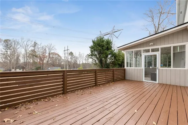a view of a roof deck with wooden floor and fence