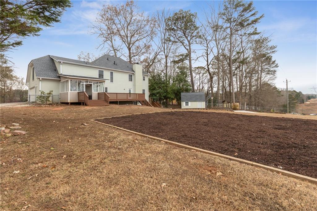 808 Valbrook Court Southwest Lilburn, GA 30047 - Photo 31 of 39 a front view of a house with a yard and garage