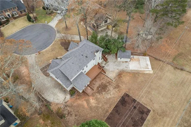 an aerial view of a house with outdoor space