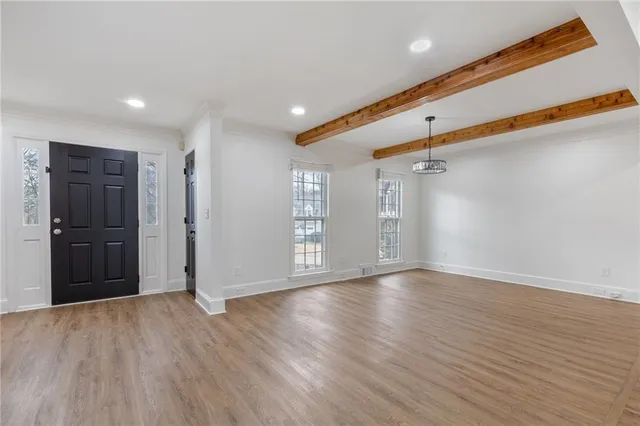 a view of an empty room with wooden floor