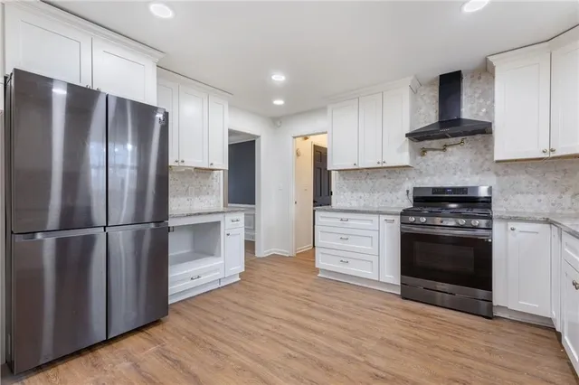 a kitchen with stainless steel appliances a refrigerator stove and sink