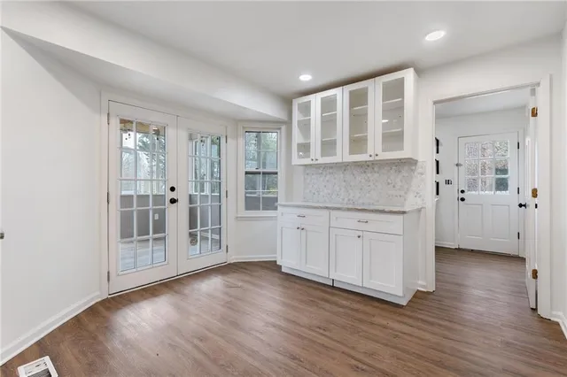 a view of wooden floor and windows in a room