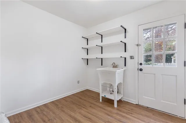 a view of a room with racks on the wall and a window