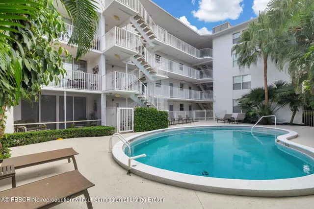 a view of a house with a swimming pool and a yard