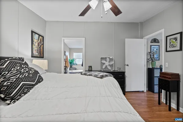 a bedroom with a bed and wooden floor