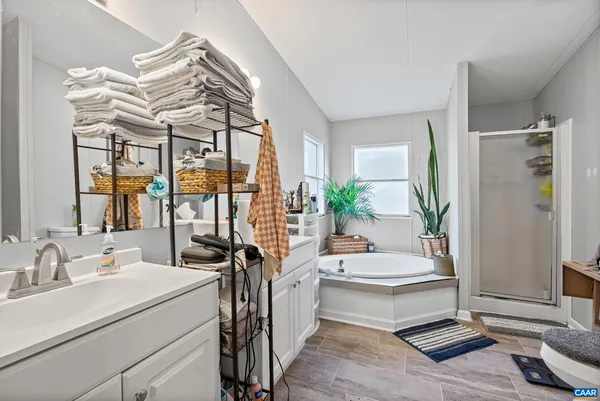 a bathroom with a sink a window and a mirror