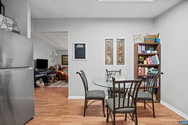 a dining room with furniture and wooden floor