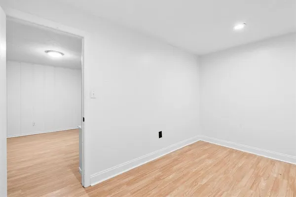 a view of a room with wooden floor