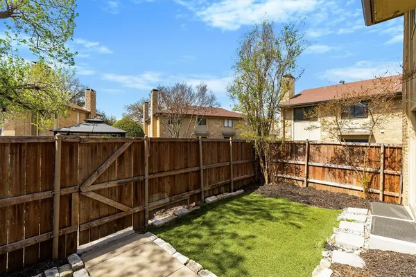 a view of a backyard with a wooden fence