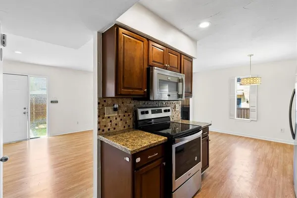 a kitchen with a stove and a microwave
