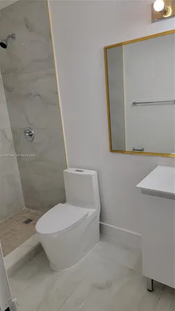 a white toilet sitting next to a bathroom sink