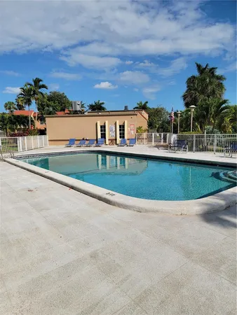 a view of a house with swimming pool and sitting area
