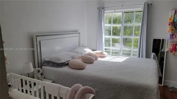 a bedroom with furniture and a window