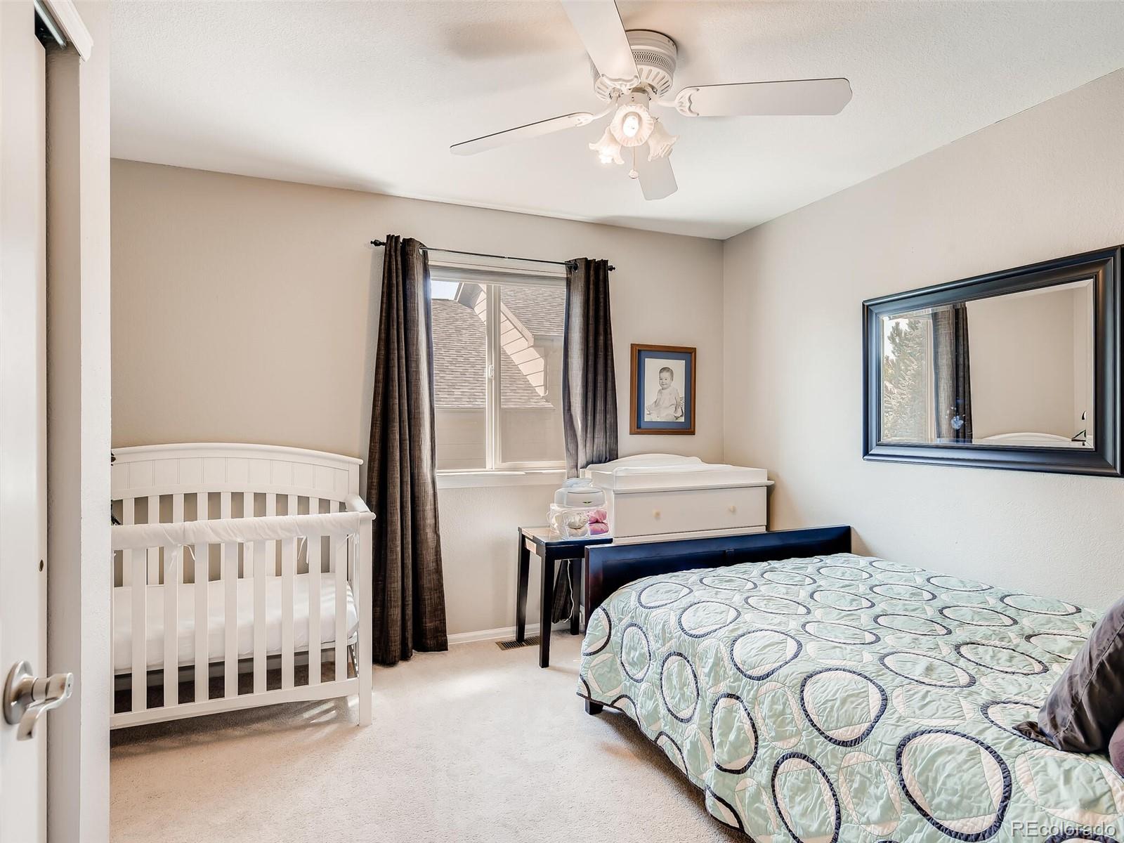 2373 Hyacinth Road Highlands Ranch, CO 80129 - Photo 17 of 38 a bedroom with a bed and a table