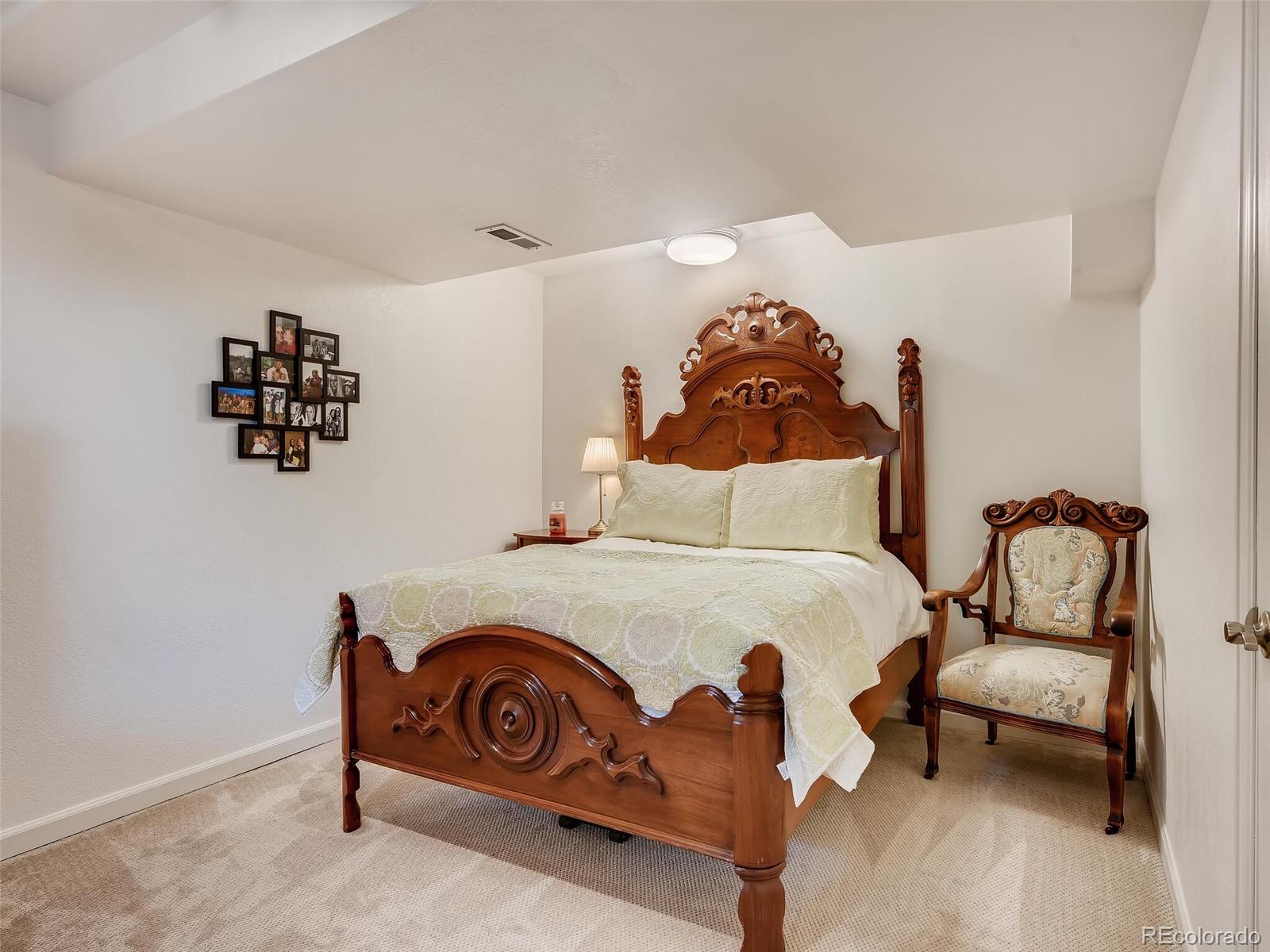 2373 Hyacinth Road Highlands Ranch, CO 80129 - Photo 20 of 38 a bedroom with a bed and a chair
