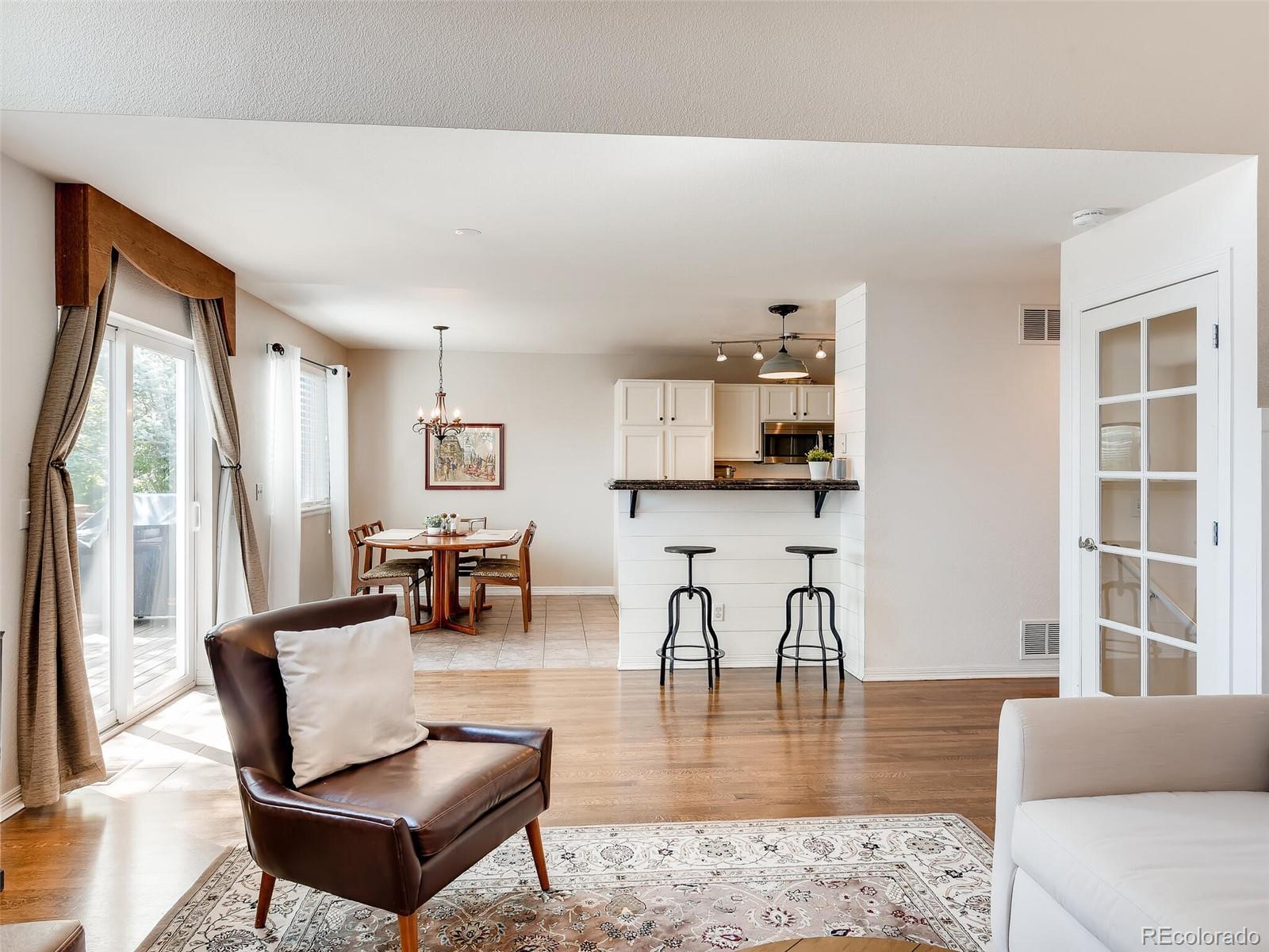 2373 Hyacinth Road Highlands Ranch, CO 80129 - Photo 2 of 38 a living room with furniture and wooden floor