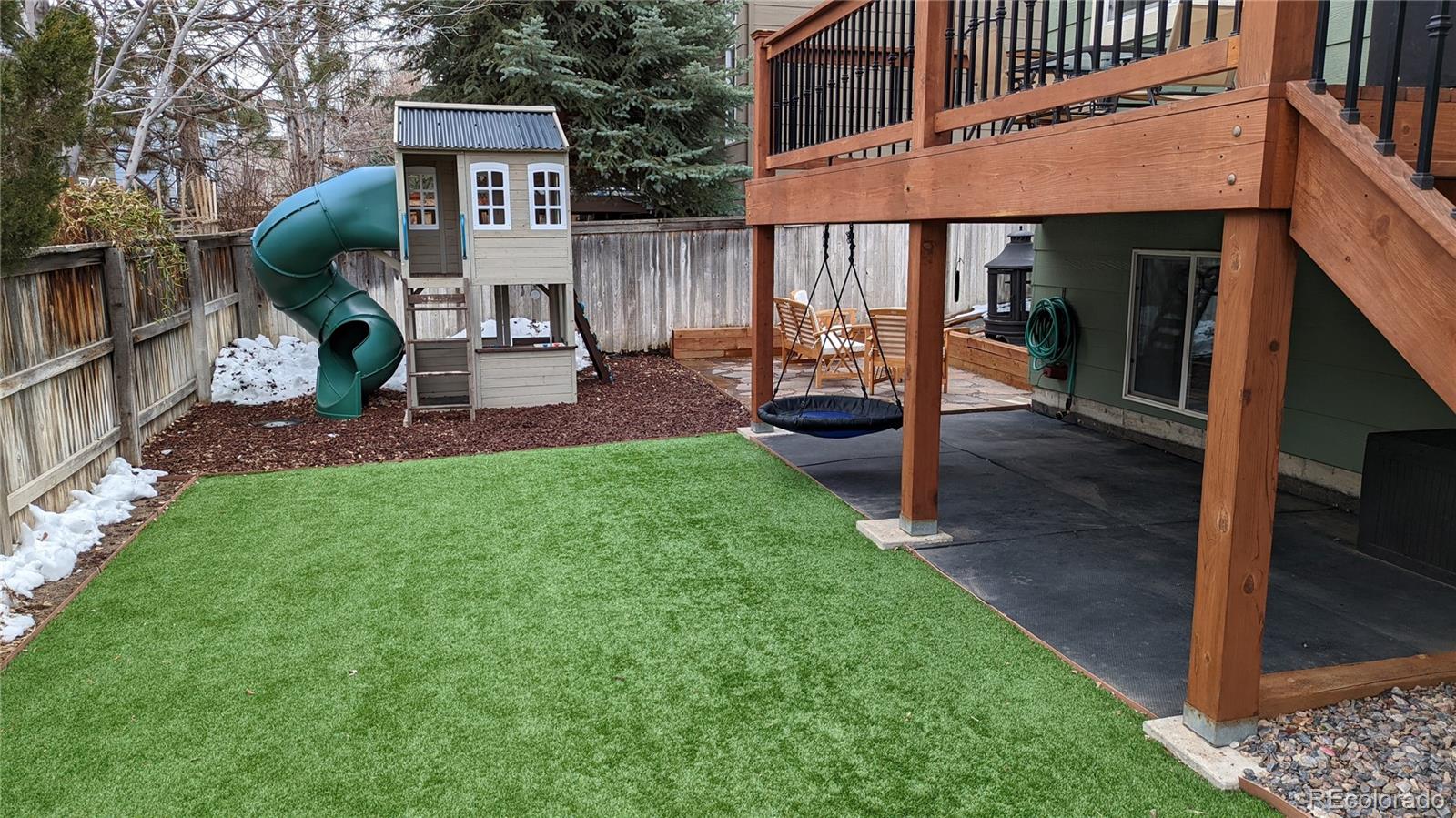2373 Hyacinth Road Highlands Ranch, CO 80129 - Photo 23 of 38 a view of a patio with table and chairs with wooden floor and fence