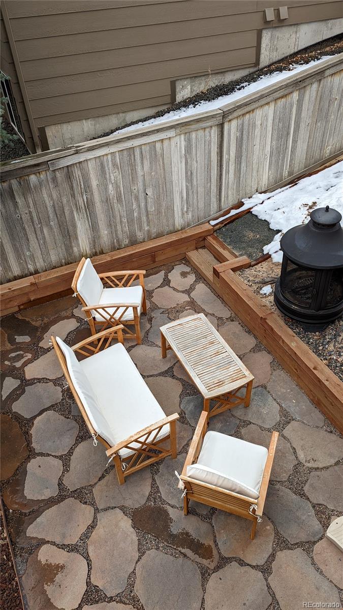 2373 Hyacinth Road Highlands Ranch, CO 80129 - Photo 26 of 38 a view of a backyard with table and chairs with wooden floor and fence