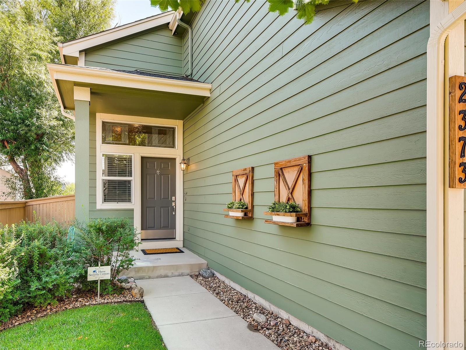2373 Hyacinth Road Highlands Ranch, CO 80129 - Photo 31 of 38 a front view of a house with garden