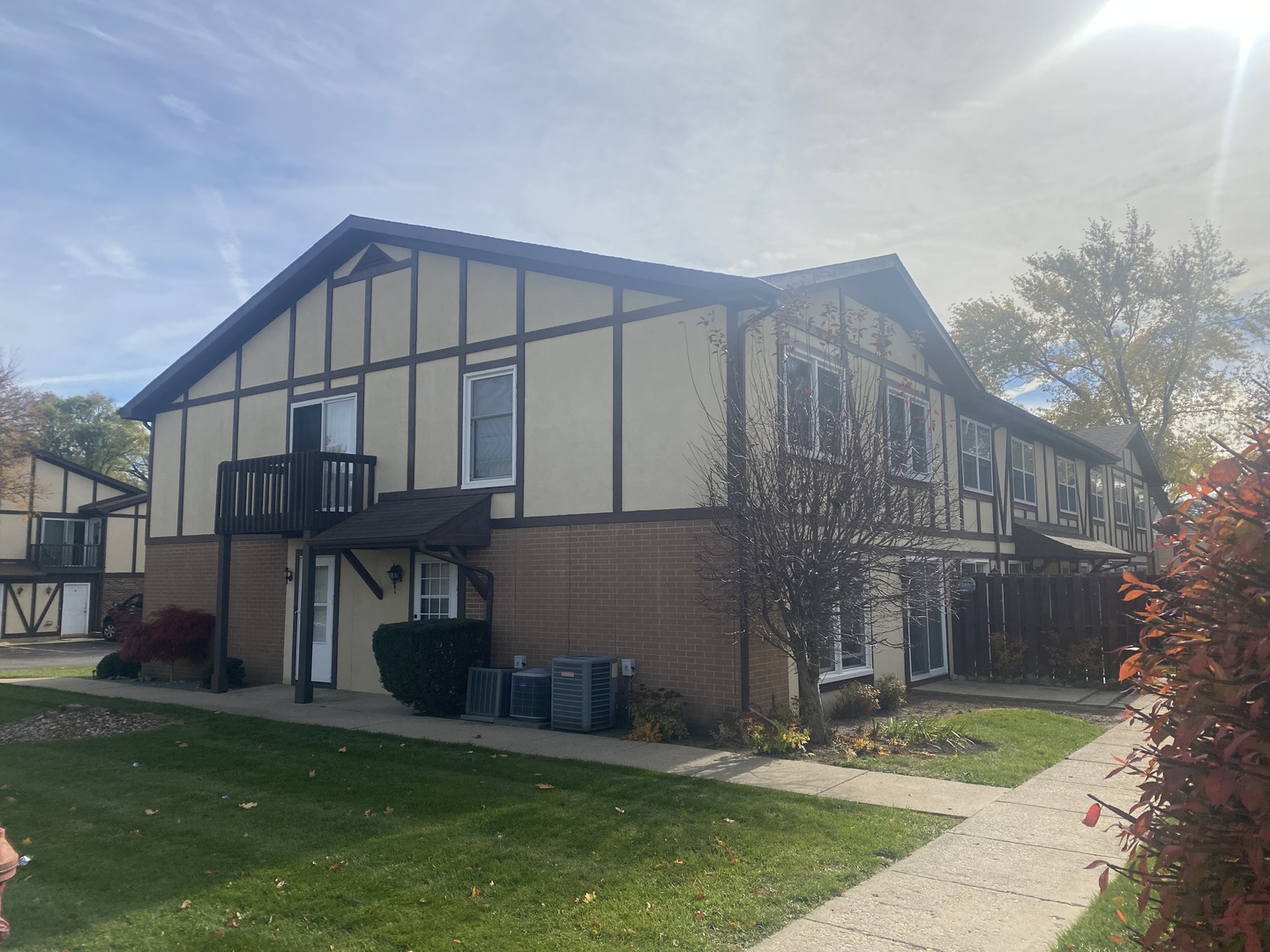 404 St Johns Road, Unit C Woodstock, IL 60098 - Photo 14 of 19 a view of a house with a small yard and a large tree