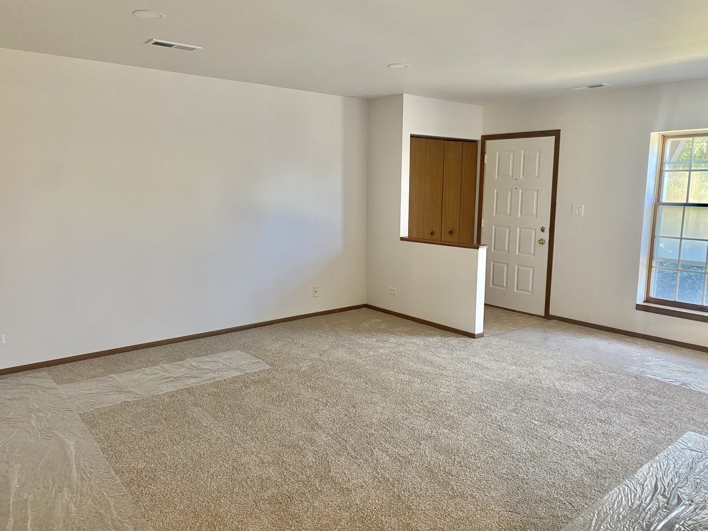 404 St Johns Road, Unit C Woodstock, IL 60098 - Photo 3 of 19 a view of an empty room with windows