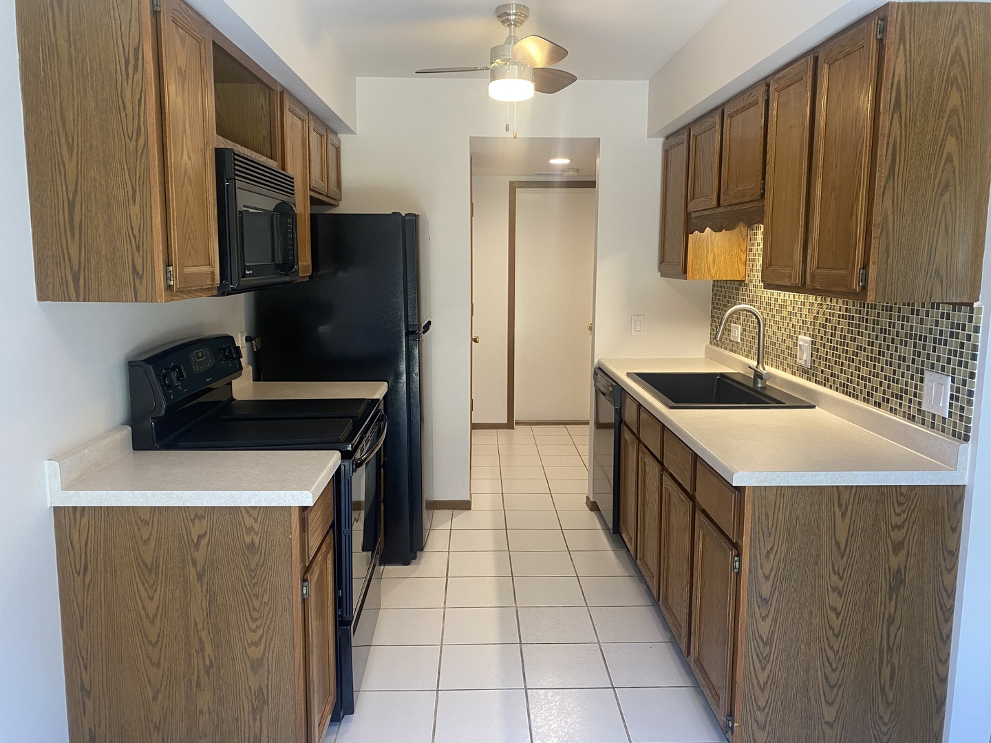 404 St Johns Road, Unit C Woodstock, IL 60098 - Photo 7 of 19 a kitchen that has a sink and a stove