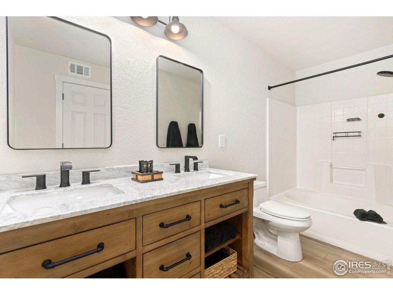 3002 West Elizabeth Street, Unit F Fort Collins, CO 80521 - Photo 11 of 18 a bathroom with a granite countertop toilet sink and mirror