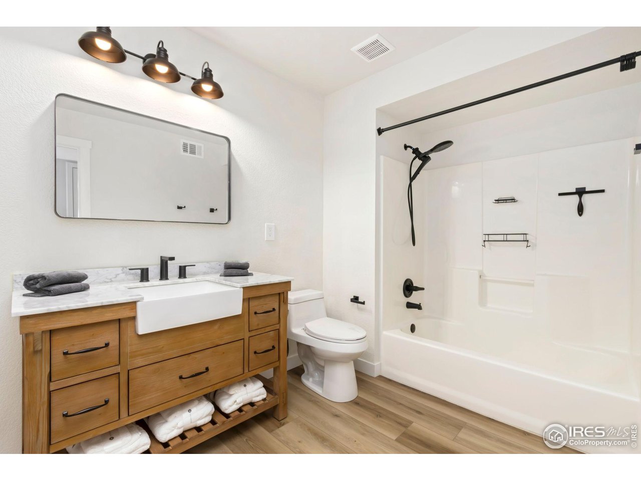 3002 West Elizabeth Street, Unit F Fort Collins, CO 80521 - Photo 12 of 18 a bathroom with a granite countertop sink mirror vanity and toilet