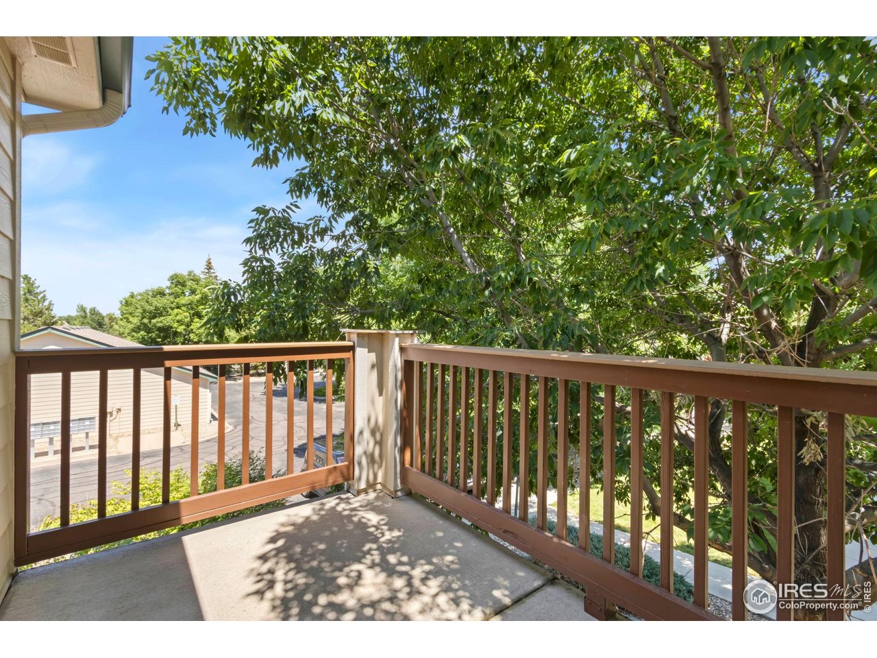 3002 West Elizabeth Street, Unit F Fort Collins, CO 80521 - Photo 15 of 18 a view of a balcony with wooden floor