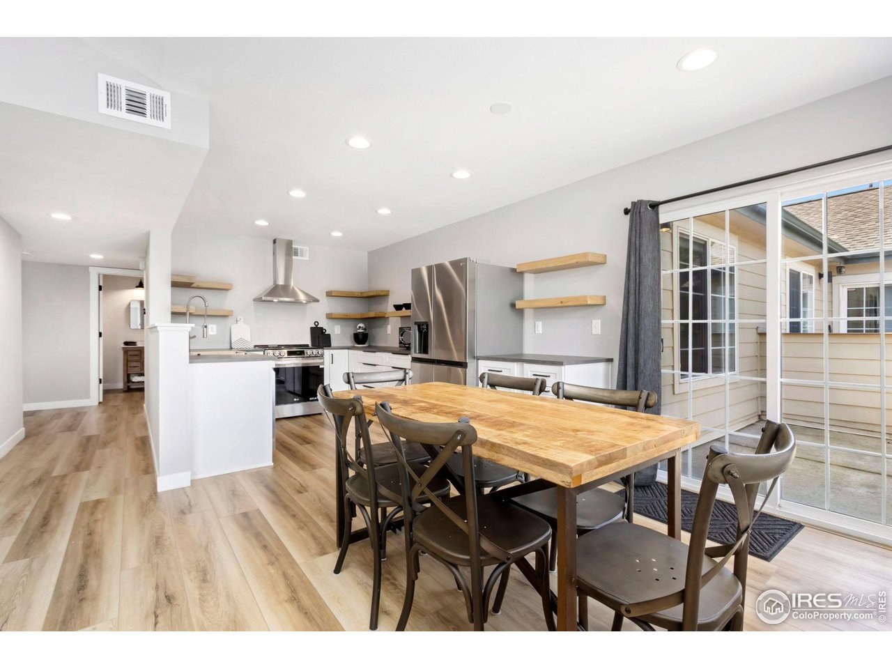 3002 West Elizabeth Street, Unit F Fort Collins, CO 80521 - Photo 3 of 18 a open dining room with stainless steel appliances kitchen island granite countertop a dining table chairs and granite counter tops