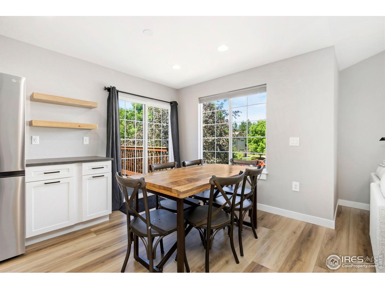 3002 West Elizabeth Street, Unit F Fort Collins, CO 80521 - Photo 4 of 18 a dining room with furniture and wooden floor