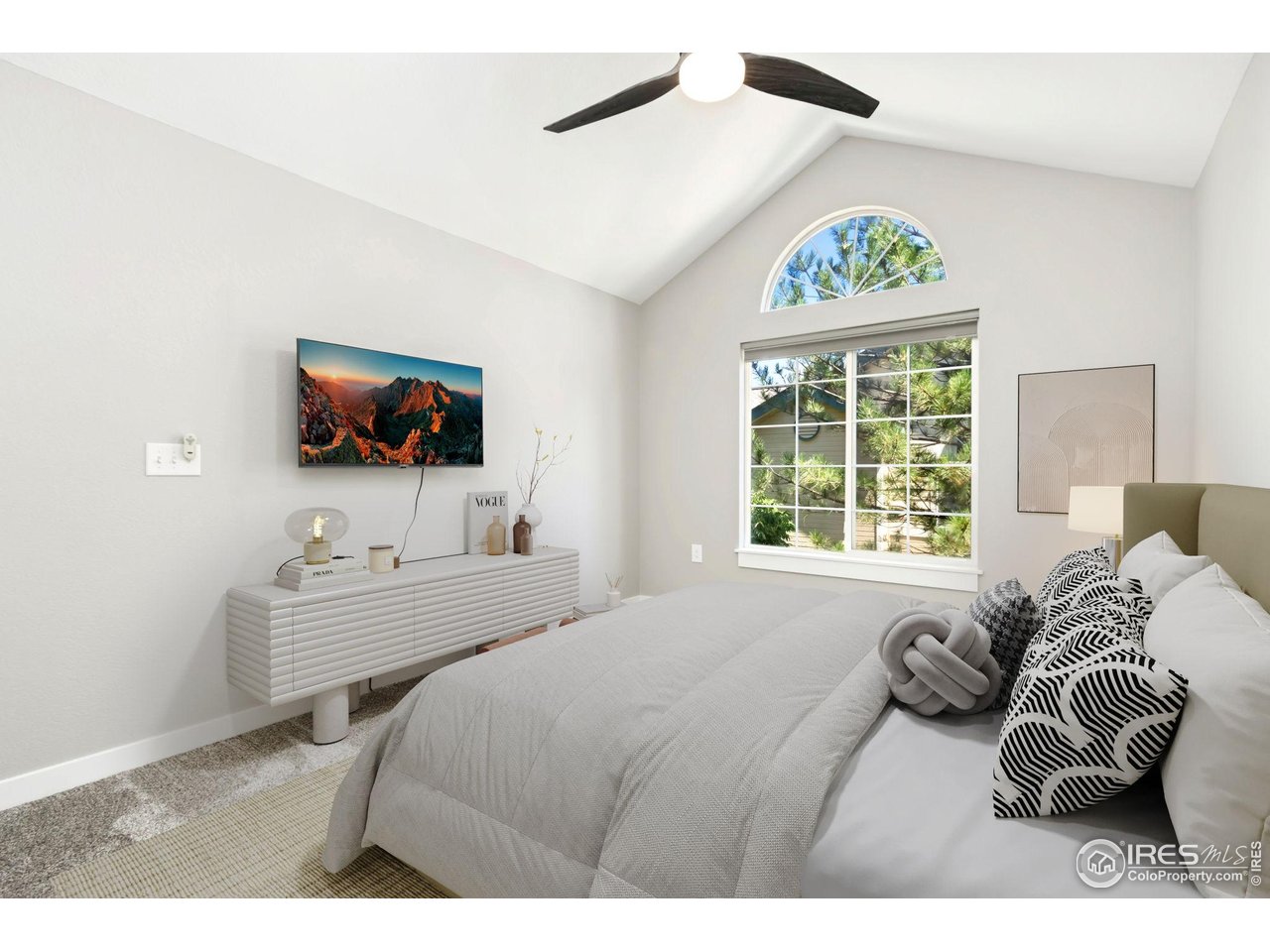 3002 West Elizabeth Street, Unit F Fort Collins, CO 80521 - Photo 10 of 18 a bedroom with furniture and a flat screen tv