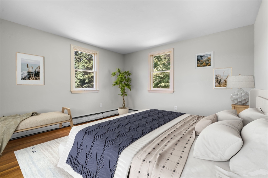 15 Seneca Road Woburn, MA 01801 - Photo 2 of 40 a bedroom with a large bed and a couch