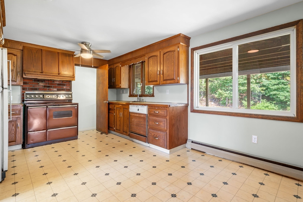 15 Seneca Road Woburn, MA 01801 - Photo 23 of 40 a kitchen with a stove a sink dishwasher a refrigerator and cabinets