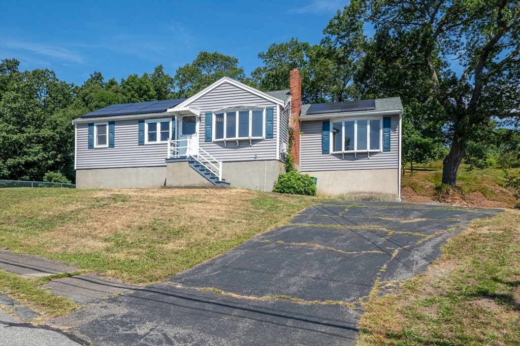 15 Seneca Road Woburn, MA 01801 - Photo 3 of 40 a front view of a house with a yard