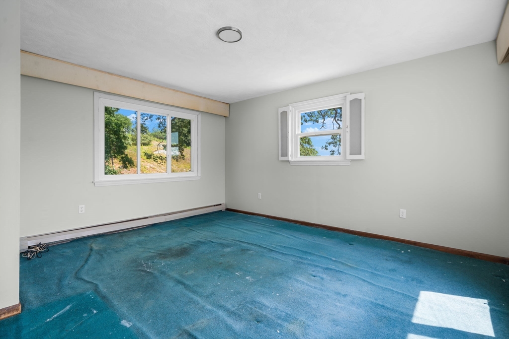 15 Seneca Road Woburn, MA 01801 - Photo 38 of 40 a view of an empty room with wooden floor and a window
