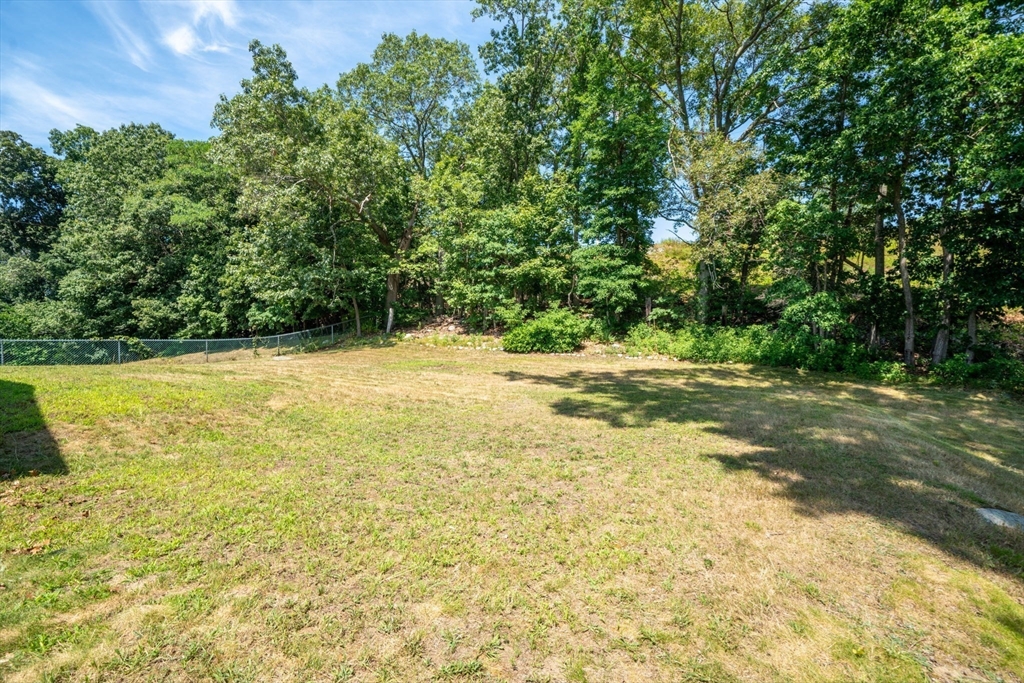 15 Seneca Road Woburn, MA 01801 - Photo 6 of 40 a view of a yard with a trees