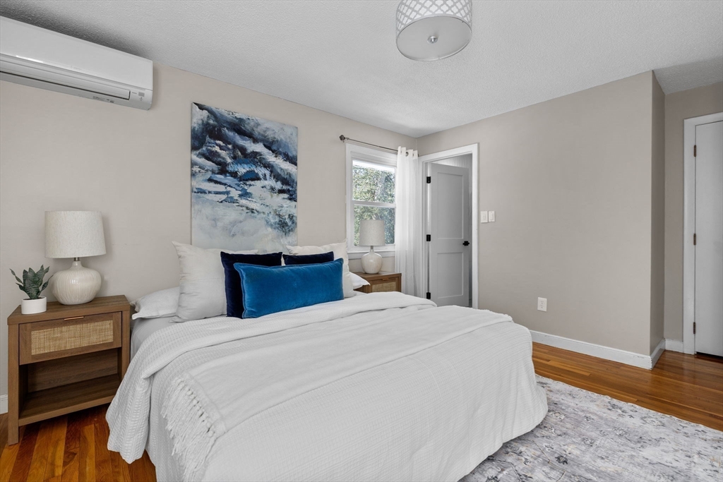 7 Dean Circle Andover, MA 01810 - Photo 13 of 36 a bedroom with a bed and a lamp on dresser