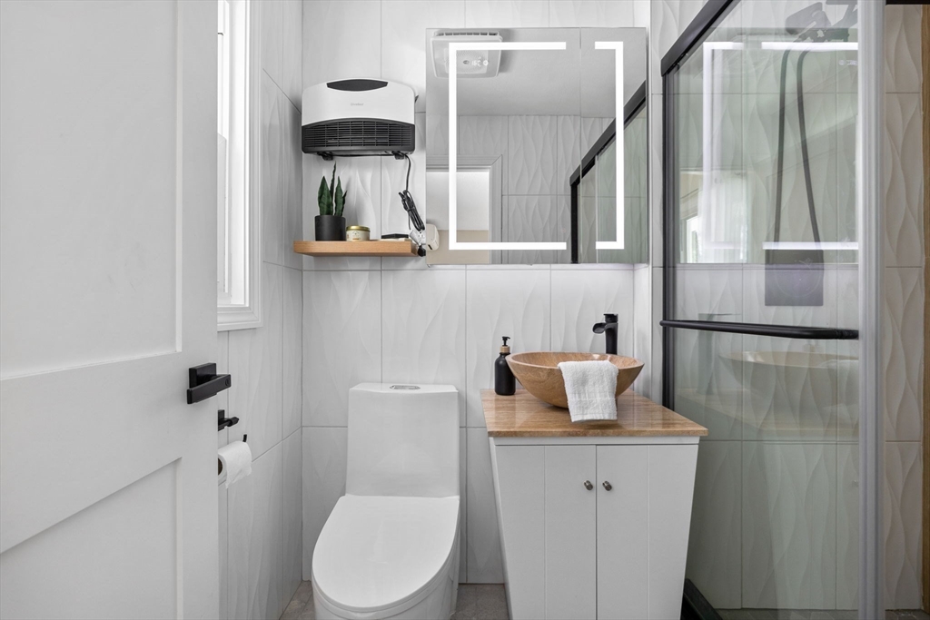 7 Dean Circle Andover, MA 01810 - Photo 15 of 36 a bathroom with a toilet sink and mirror
