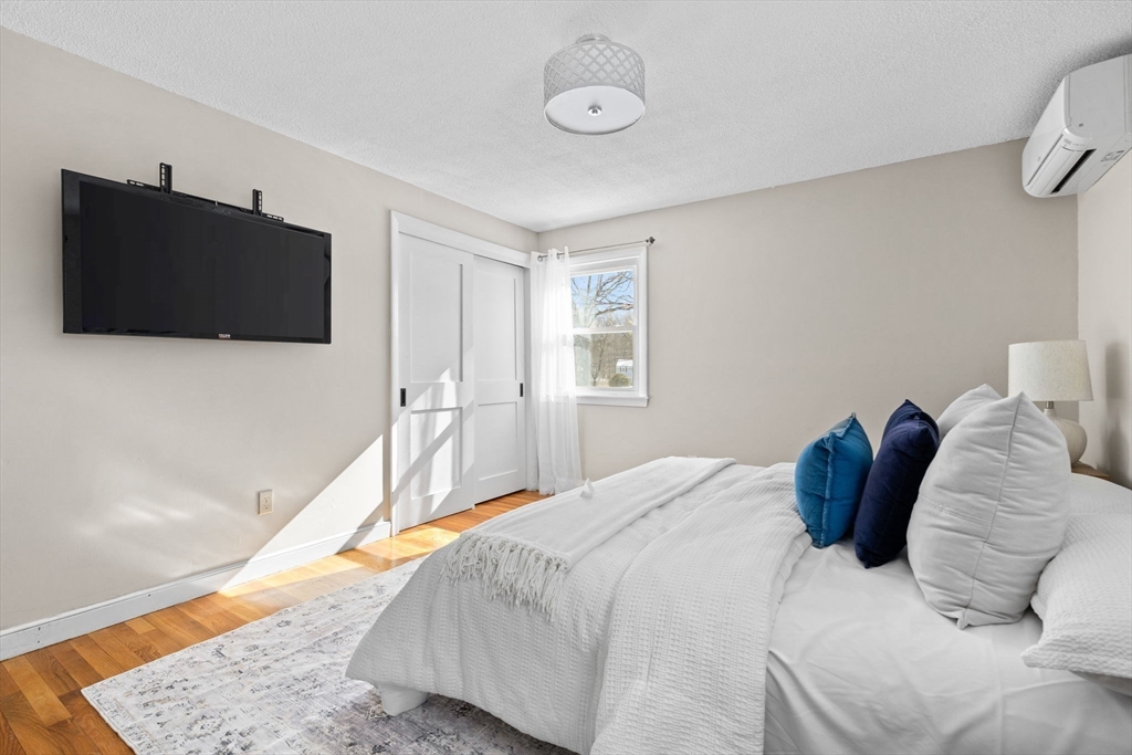 7 Dean Circle Andover, MA 01810 - Photo 17 of 36 a bedroom with a bed and a flat screen tv