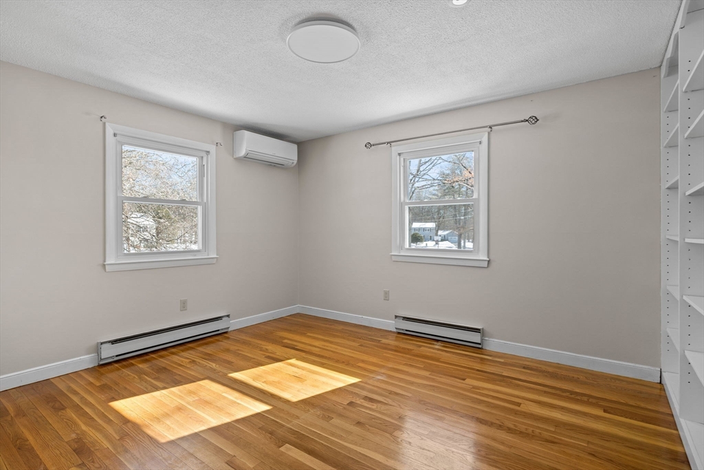 7 Dean Circle Andover, MA 01810 - Photo 20 of 36 a view of a room with wooden floor and window