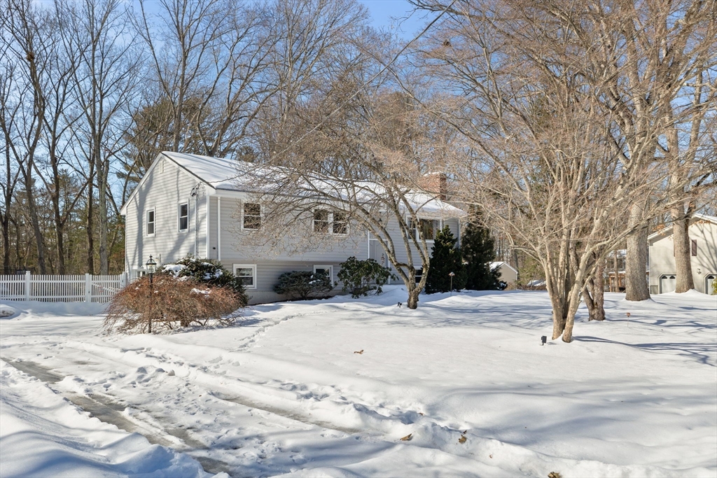 7 Dean Circle Andover, MA 01810 - Photo 2 of 36 a view of a white house with a snow on the road