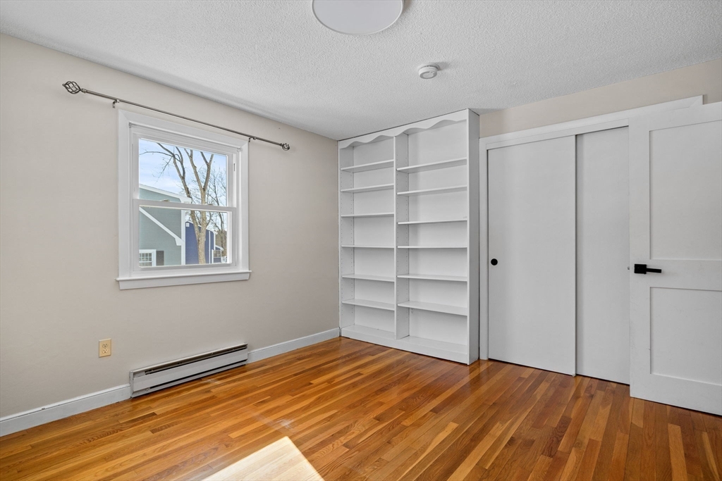 7 Dean Circle Andover, MA 01810 - Photo 21 of 36 a view of empty room with wooden floor and fan