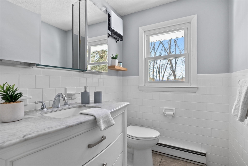 7 Dean Circle Andover, MA 01810 - Photo 22 of 36 a bathroom with a granite countertop sink a toilet and a mirror