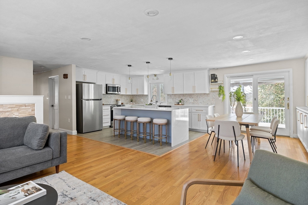 7 Dean Circle Andover, MA 01810 - Photo 24 of 36 a living room with stainless steel appliances kitchen island granite countertop furniture and a kitchen view