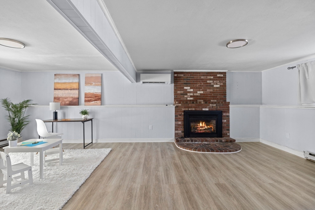 7 Dean Circle Andover, MA 01810 - Photo 26 of 36 a living room with furniture and a fireplace