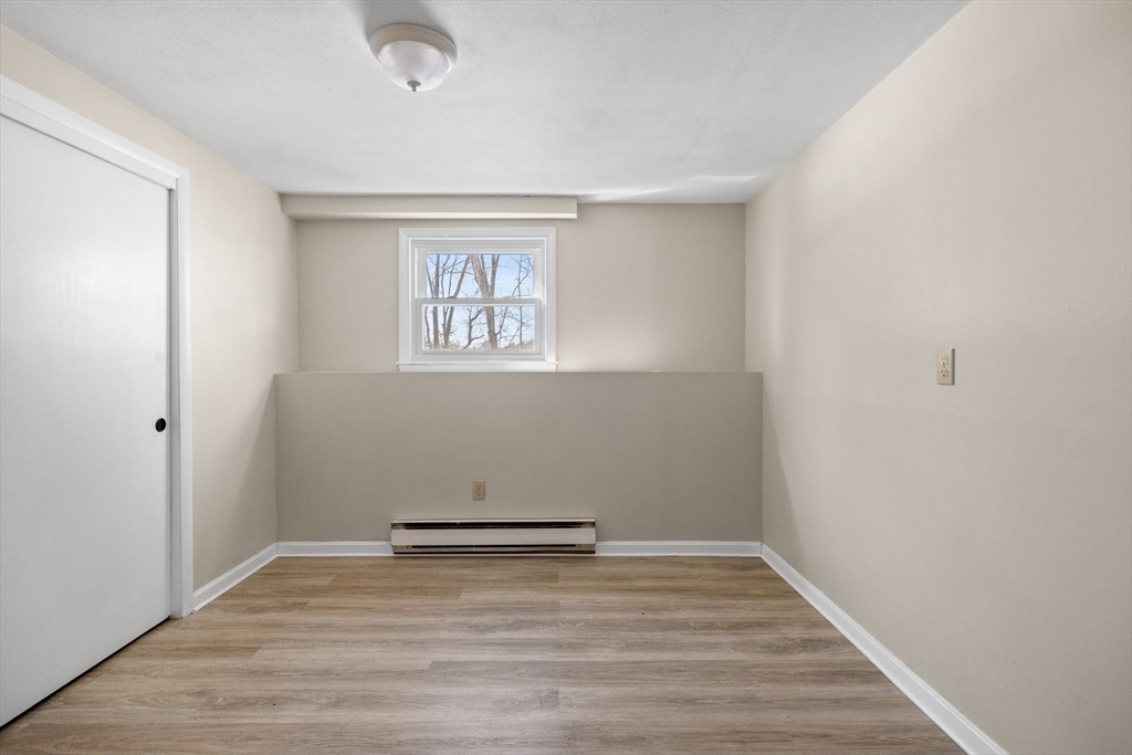 7 Dean Circle Andover, MA 01810 - Photo 31 of 36 a view of a room with wooden floor and white walls