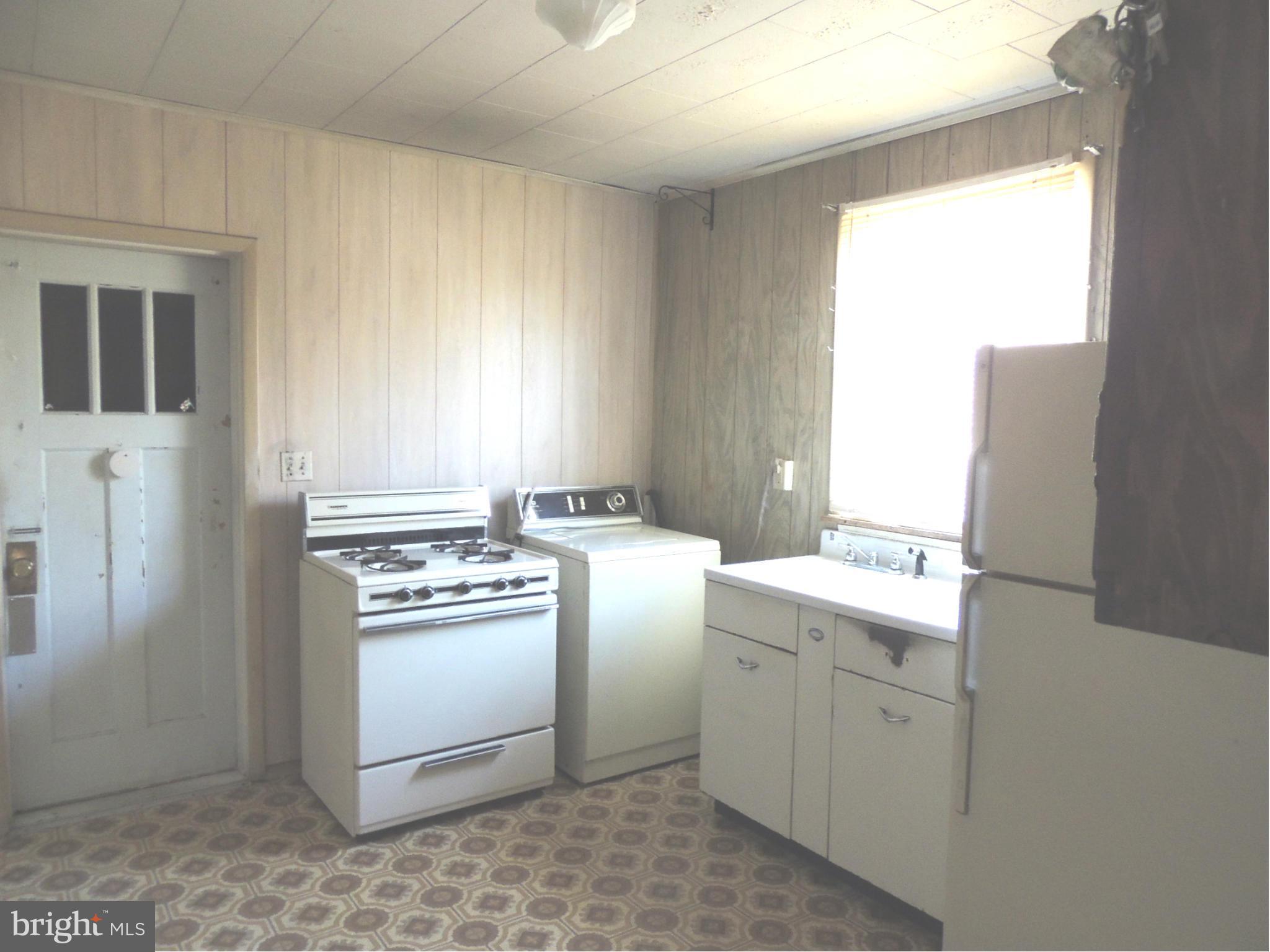 2124 Oak Road Baltimore, MD 21219 - Photo 9 of 20 a kitchen with a stove and a refrigerator