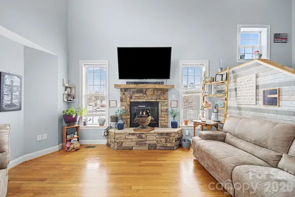 a living room with furniture and large windows