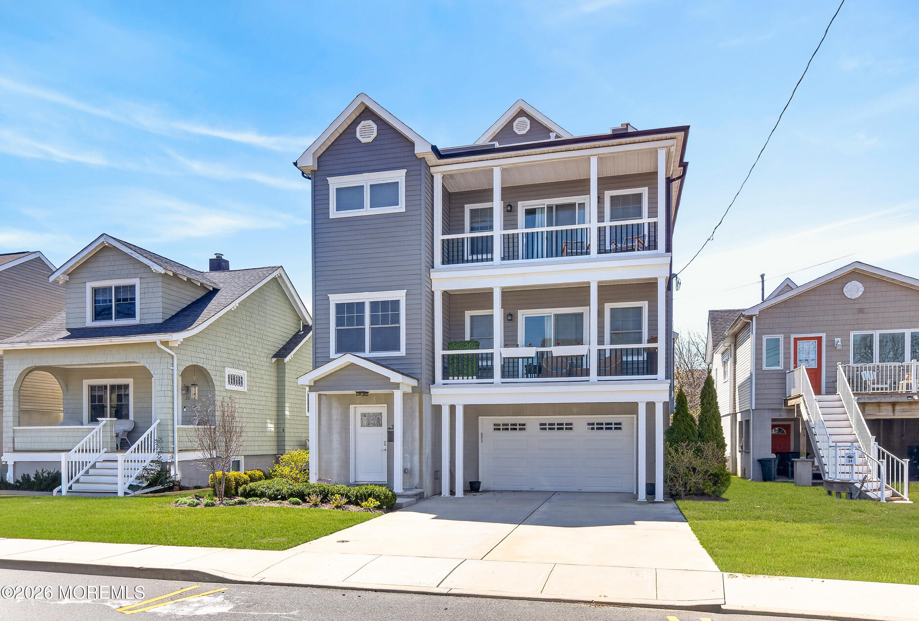 27 5th Street Highlands, NJ 07732 - Photo 50 of 62 a front view of a house with a garden and trees